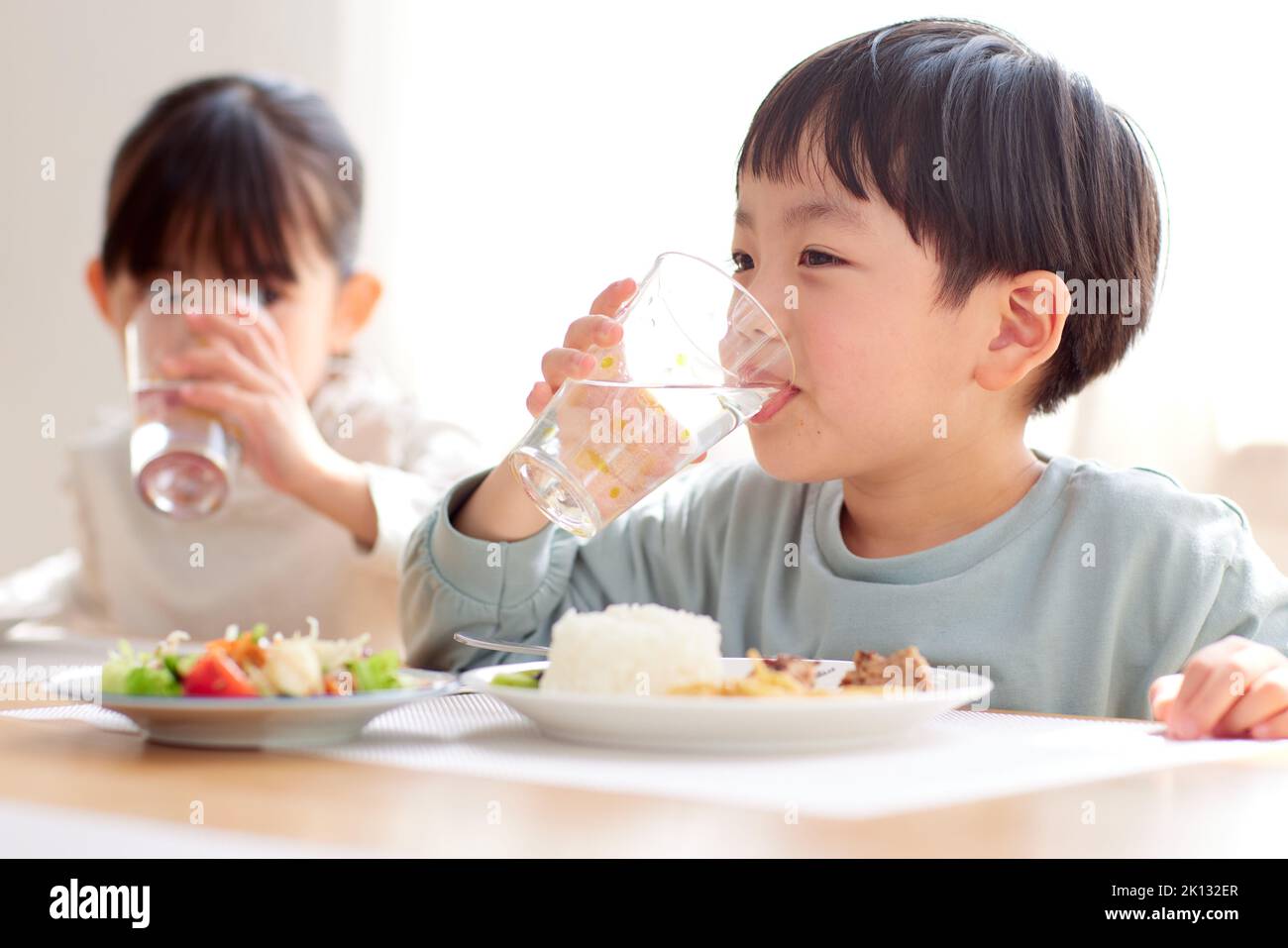 Japanese kids eating together at home Stock Photo Alamy