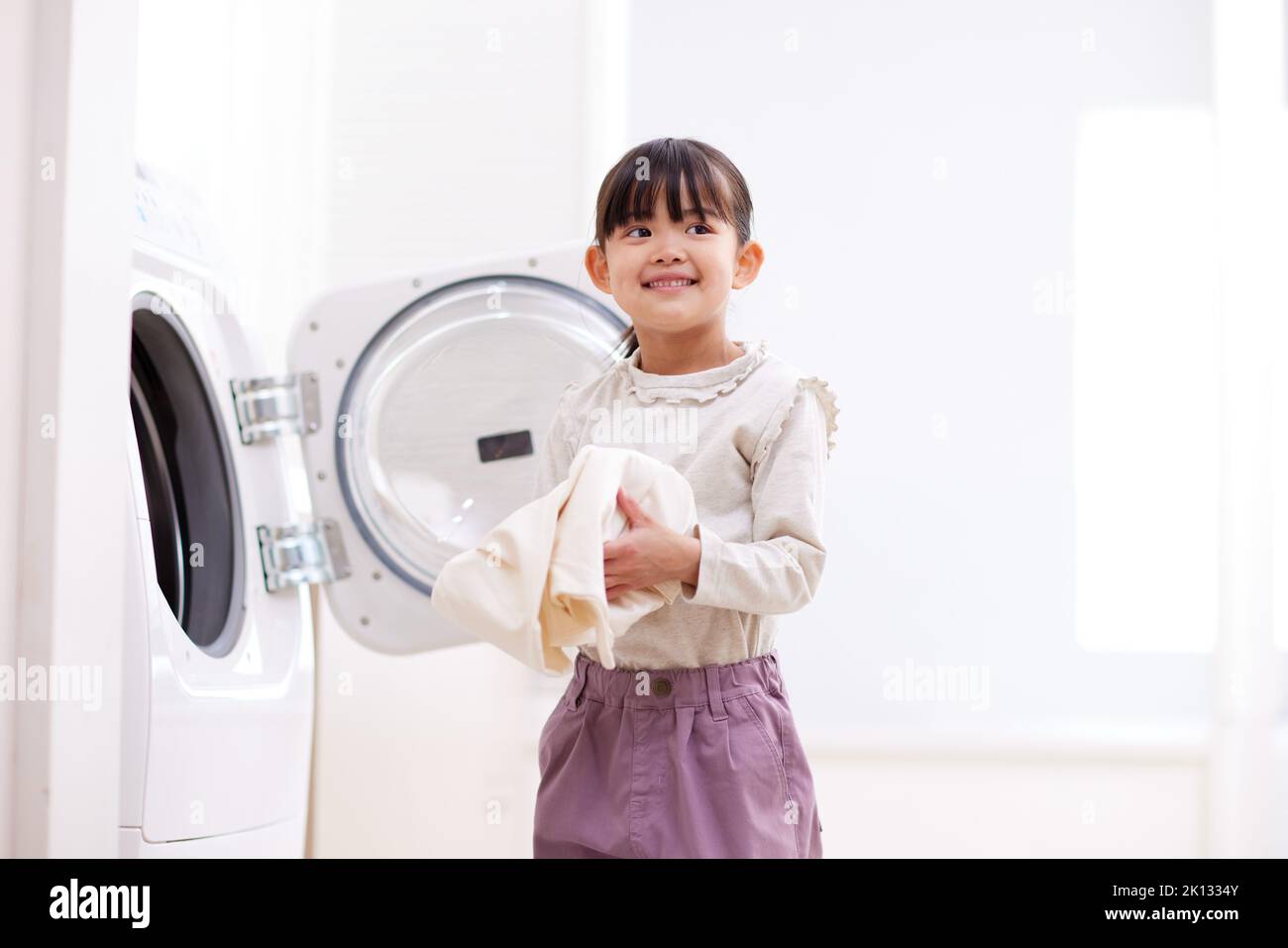 Japanese kid doing laundry at home Stock Photo Alamy