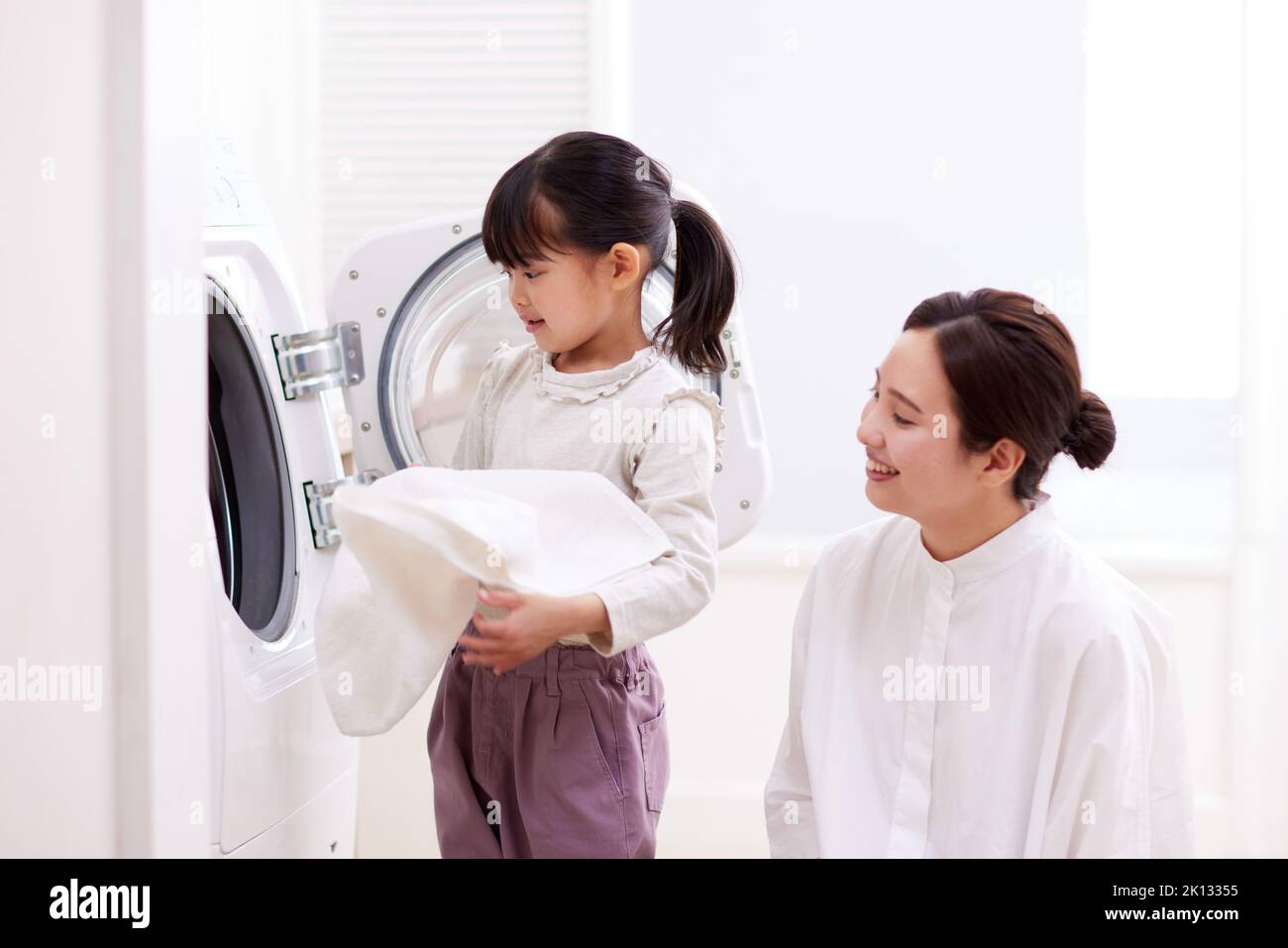 Japanese kid and mother doing laundry at home Stock Photo Alamy