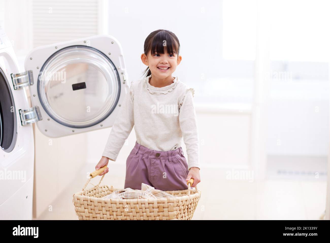 Japanese kid doing laundry at home Stock Photo Alamy