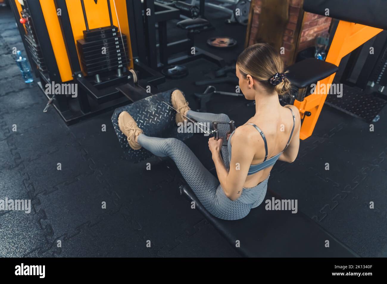 young girl working out hard at the gym, full shot sporty lifestyle. High quality photo Stock Photo