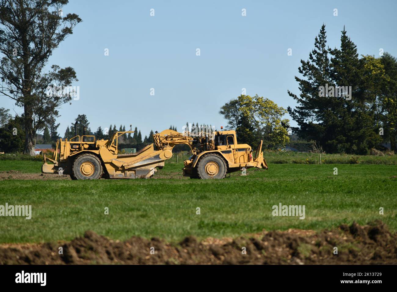 A large scraper at work on a property near Darfield, Canterbury, New Zealand Stock Photo