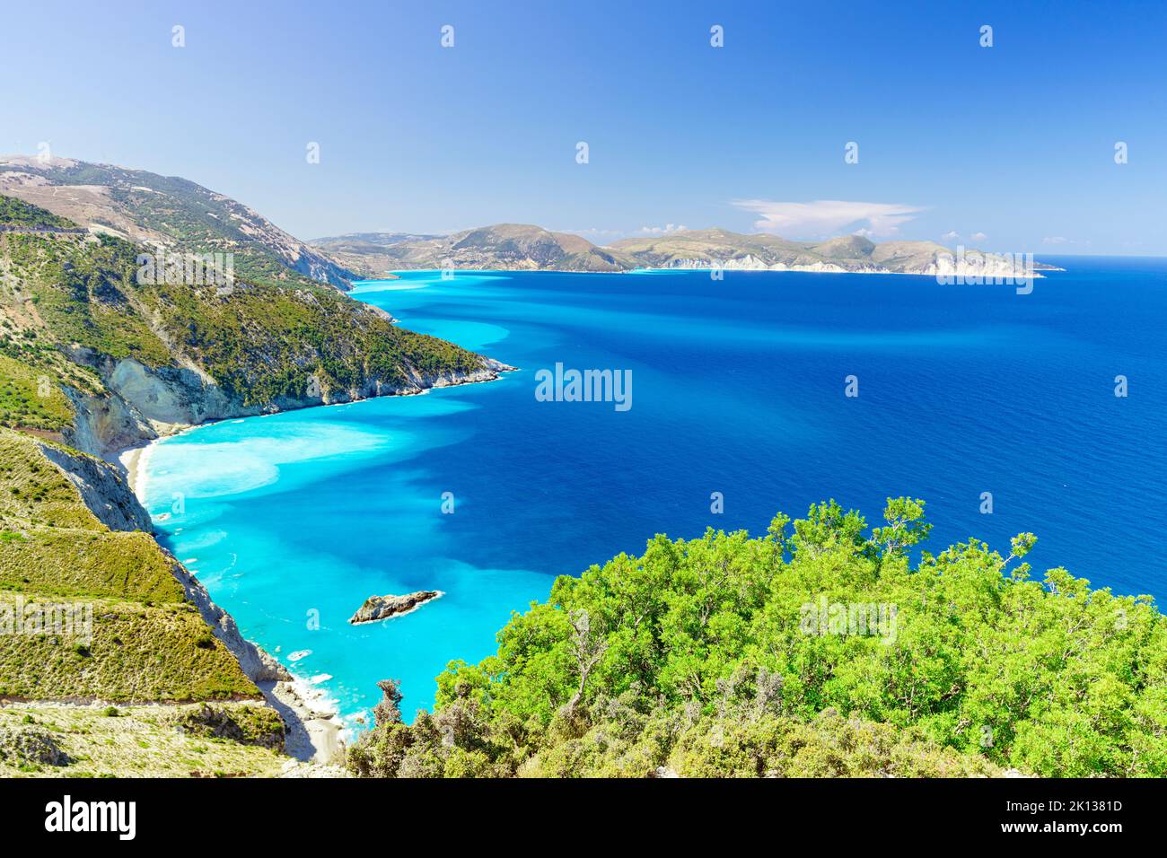 Lush plants on coastline above the turquoise lagoon surrounding Myrtos beach, Kefalonia, Ionian Islands, Greek Islands, Greece, Europe Stock Photo