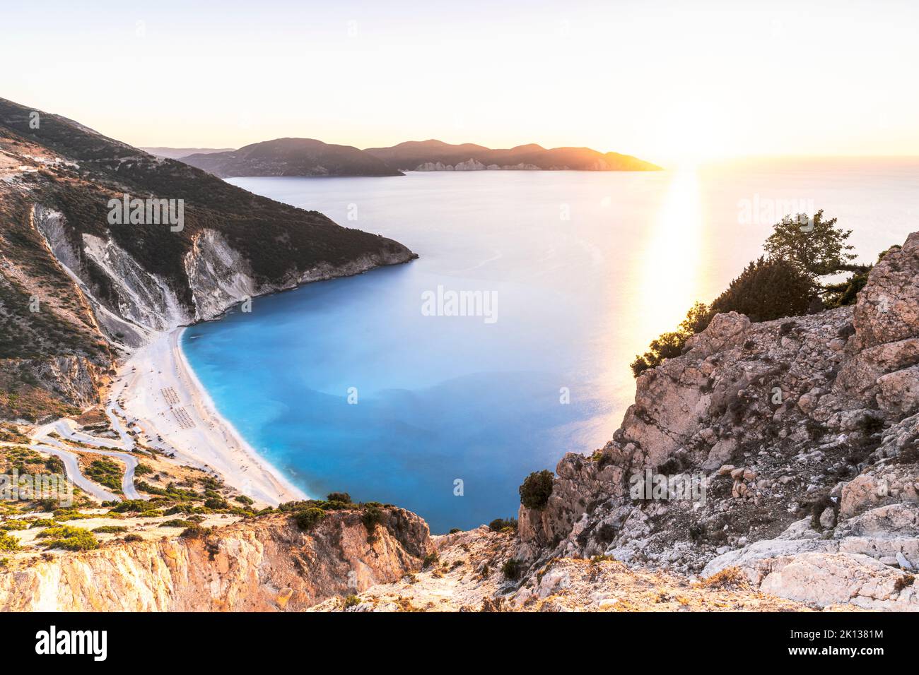 Sunset reflecting in the blue Ionian Sea surrounding Myrtos beach, view from high cliffs, Kefalonia, Greek Islands, Greece, Europe Stock Photo