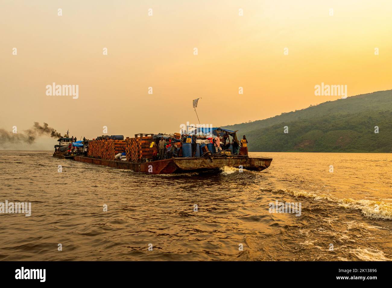 Overloaded riverboat on the Congo River at sunset, Democratic Republic