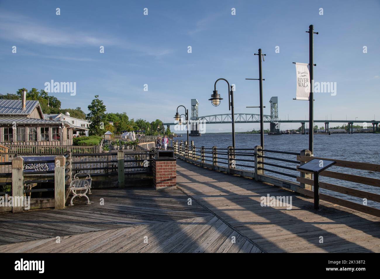 Sunset on the Riverwalk along the Cape Fear River with river bridge in the background, Wilmington, North Carolina, United States of America Stock Photo