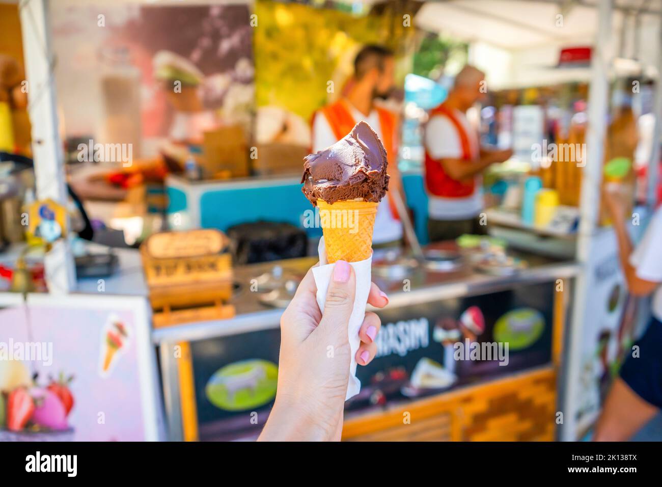 Manavgat, Turkey - September 8, 2022: Turkish ice cream Dondurma in hand on the background of the city. Stock Photo