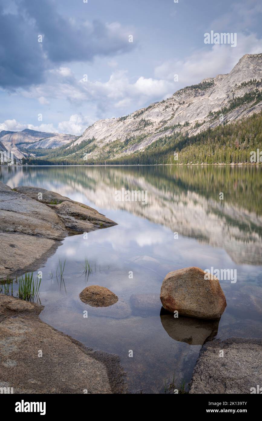 Mountain reflections in the tranquil waters of Tenaya Lake in Yosemite National Park Stock Photo