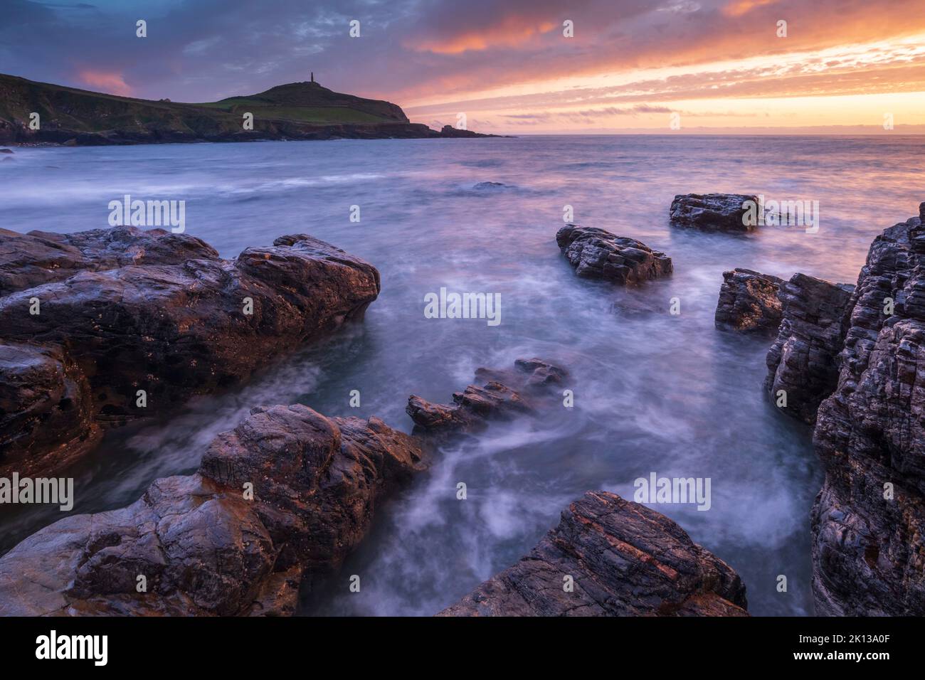 Sunset over Cape Cornwall from the rocky shores of Porth Ledden, Cornwall, England, United Kingdom, Europe Stock Photo