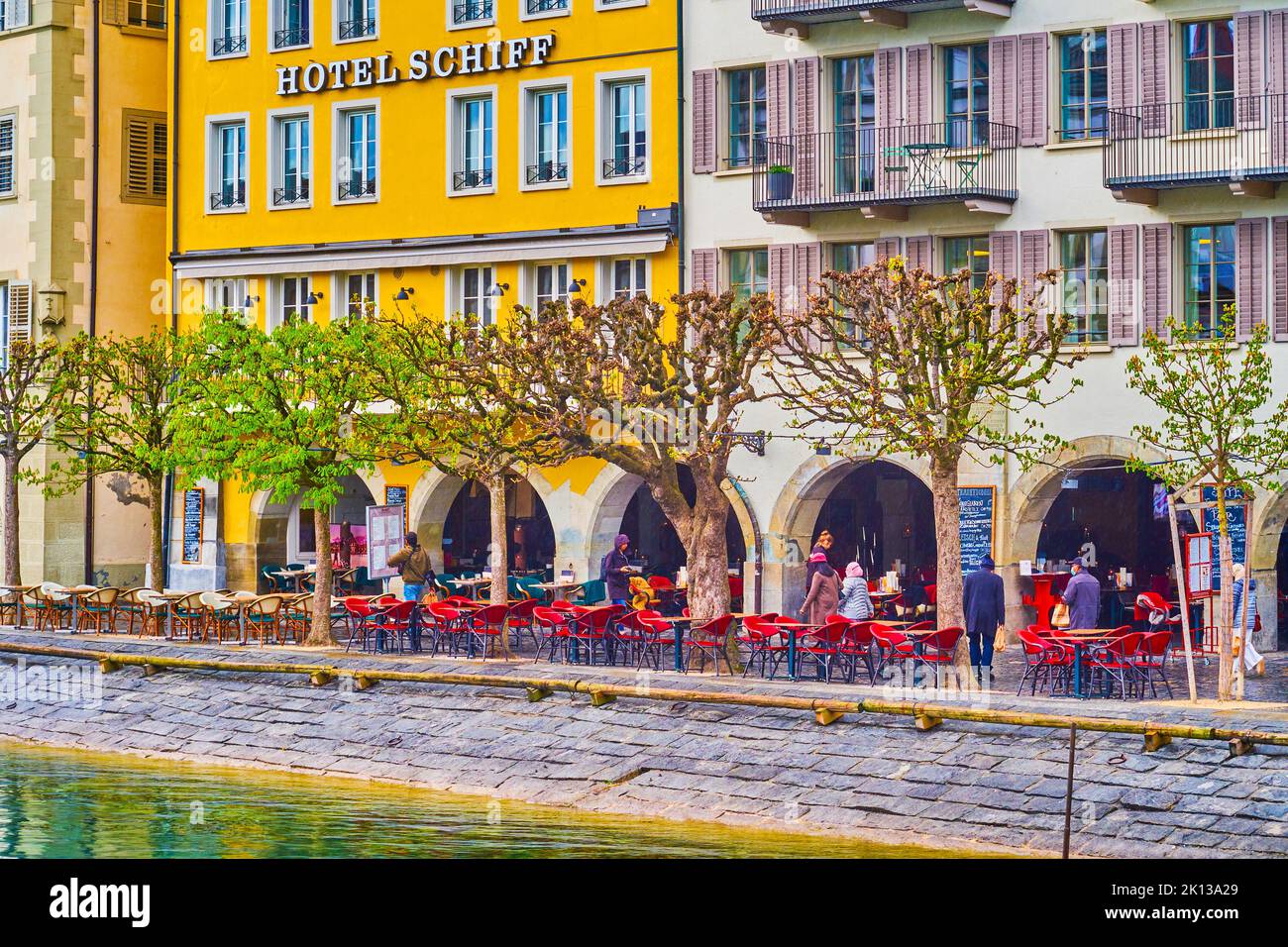 LUCERNE, SWITZERLAND - MARCH 30, 2022: Outdoor restaurants on Unter der Egg embankment of old town, on March 30 in Lucerne, Switzerland Stock Photo
