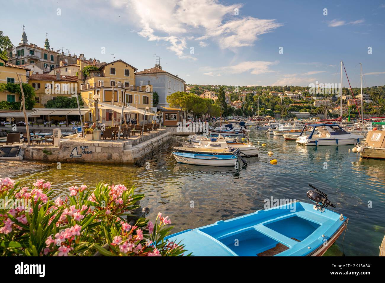 View of boats in the marina and harbourside restaurants during golden hour in Volosko, Opatija, Kvarner Bay, Croatia, Europe Stock Photo