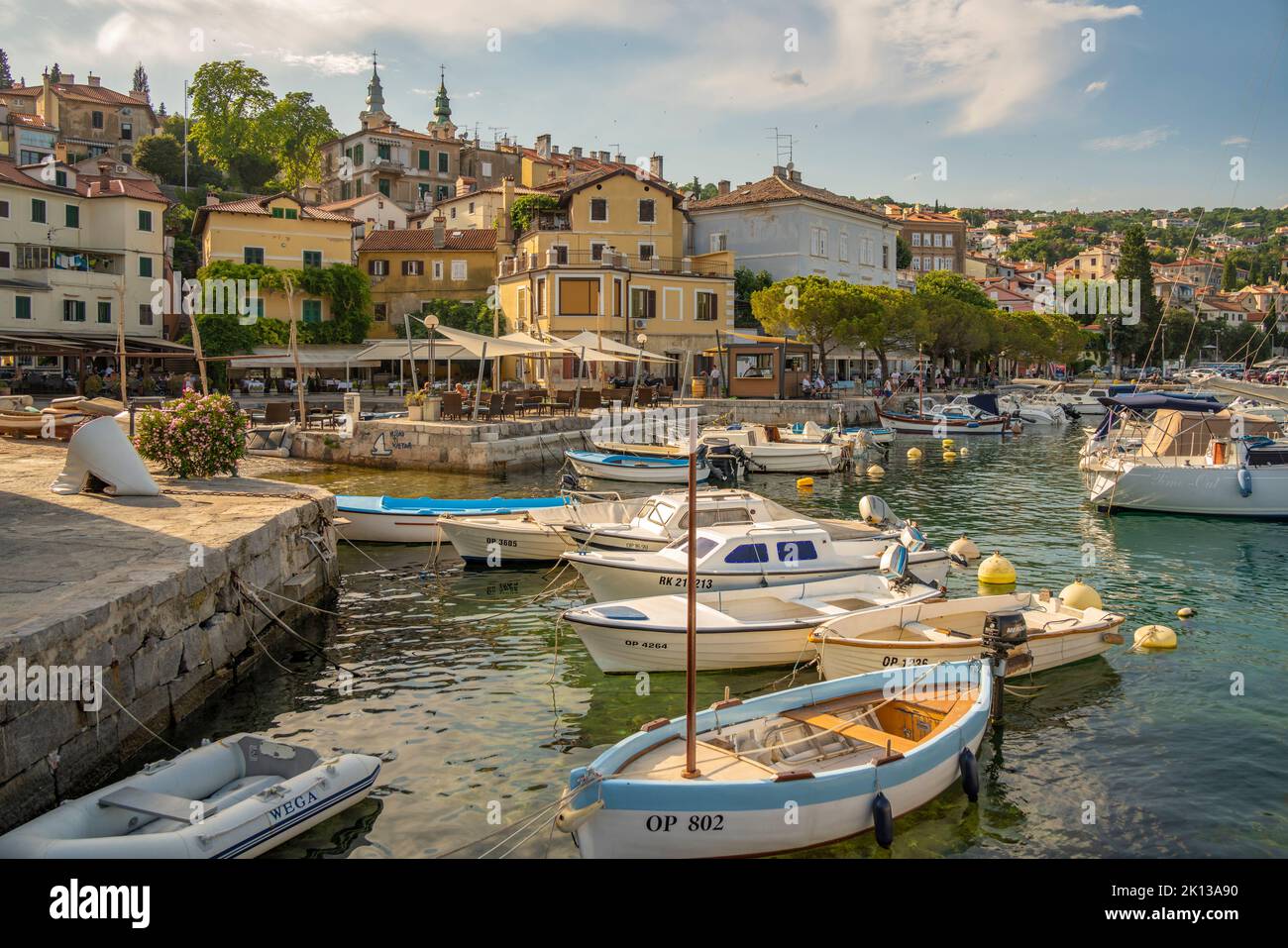 View of boats in the marina and harbourside restaurants during golden hour in Volosko, Opatija, Kvarner Bay, Croatia, Europe Stock Photo