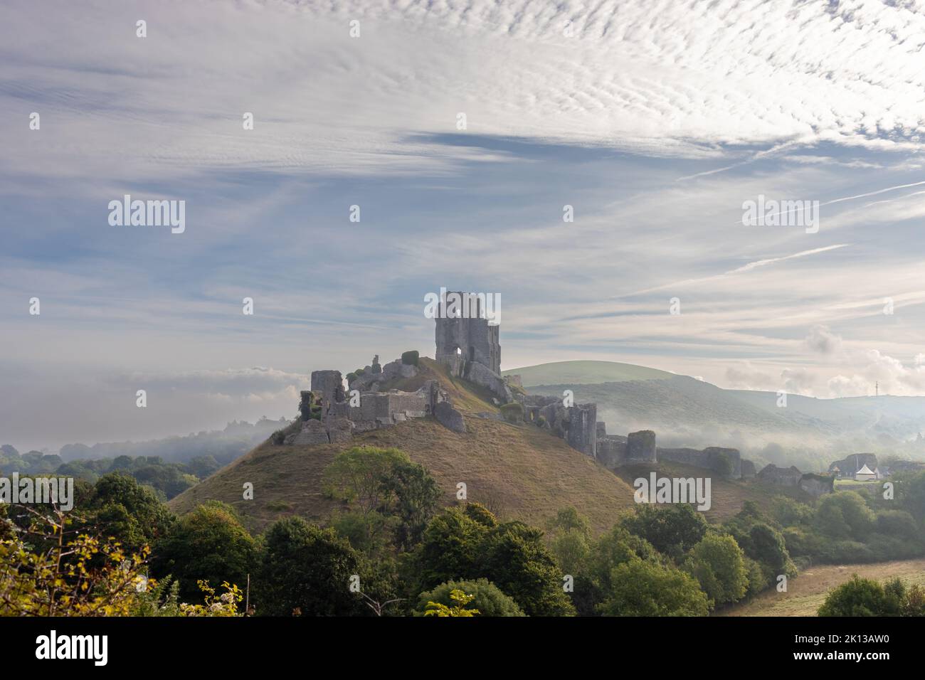 View of Corfe Castle in the Isle of Purbeck, Dorset, England on a misty morning in September Stock Photo