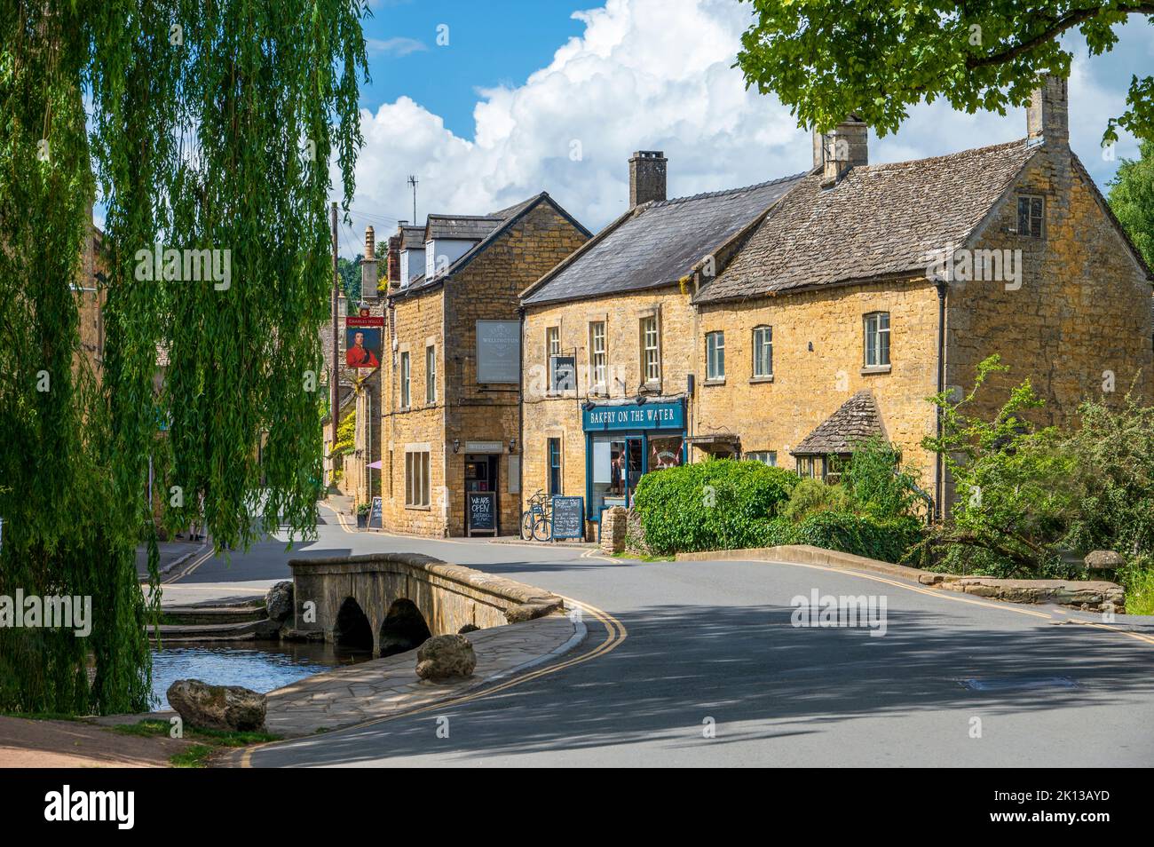 Village scene with bridge over River Windrush, Bourton-on-the-Water, Cotswolds, Gloucestershire, England, United Kingdom, Europe Stock Photo