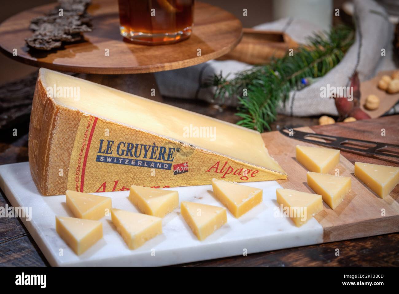 July 12 2022, Lyon, France : Tasted famous swiss cheese : Le Gruyère d'Alpage with milk and honey for lunch and food experience Stock Photo