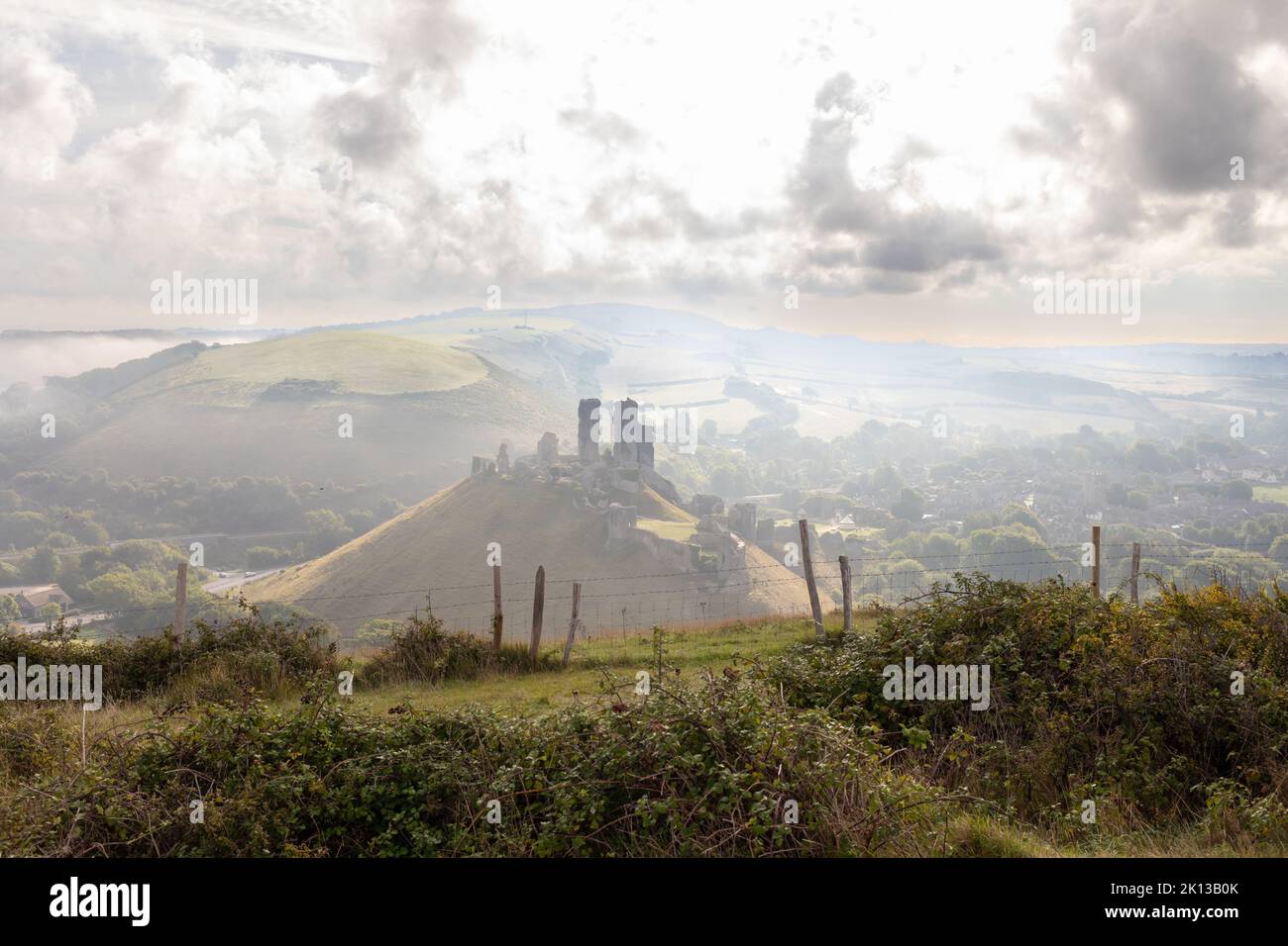 Misty morning view of Corfe Castle in the Isle of Purbeck, Dorset, England Stock Photo