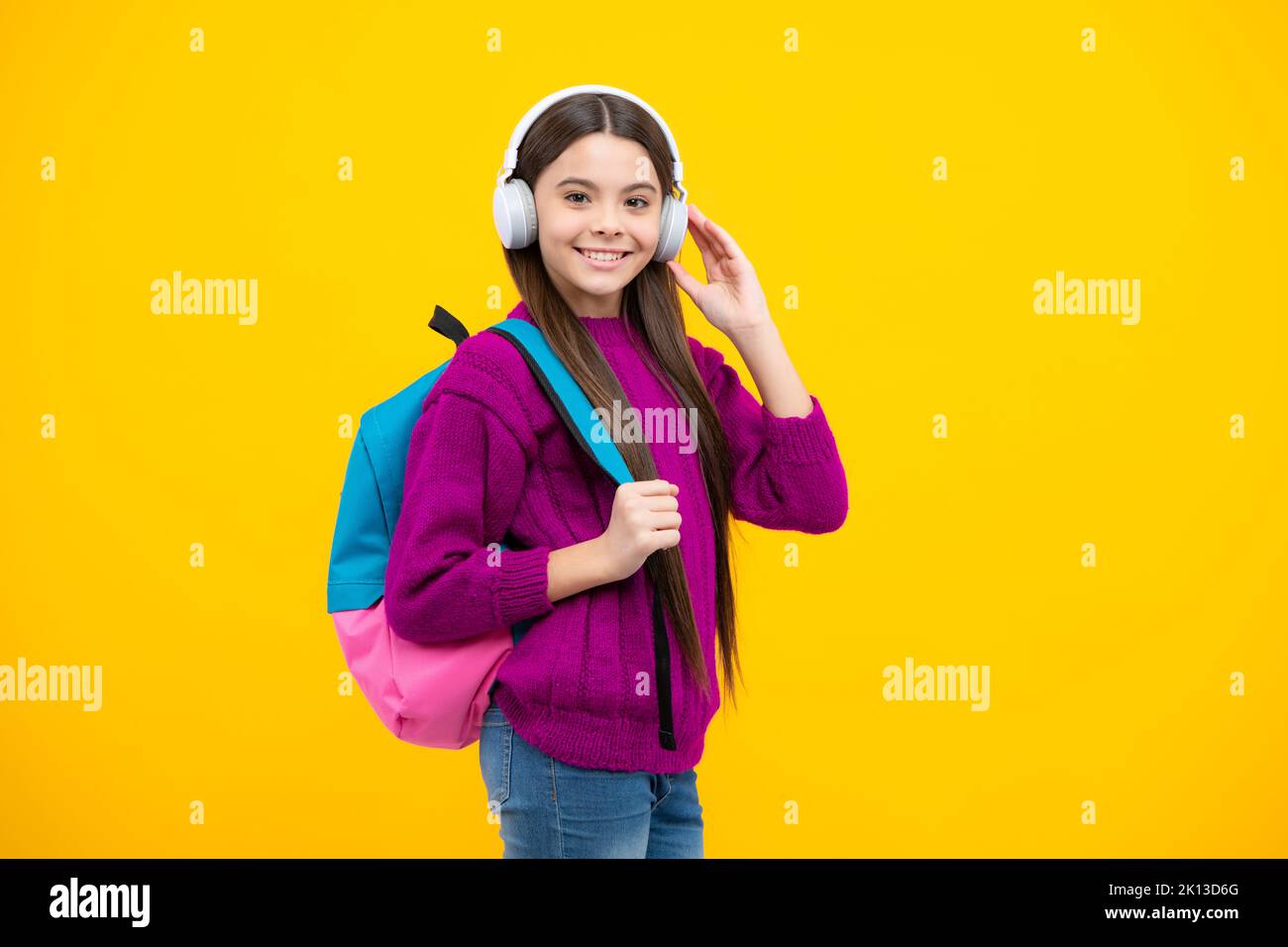 Back to school. Schoolgirl student in headphones with school bag ...