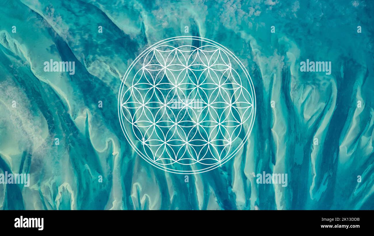 Flower of life sacred geometry symbol on turquoise blue ocean waters background or HD wallpaper Stock Photo