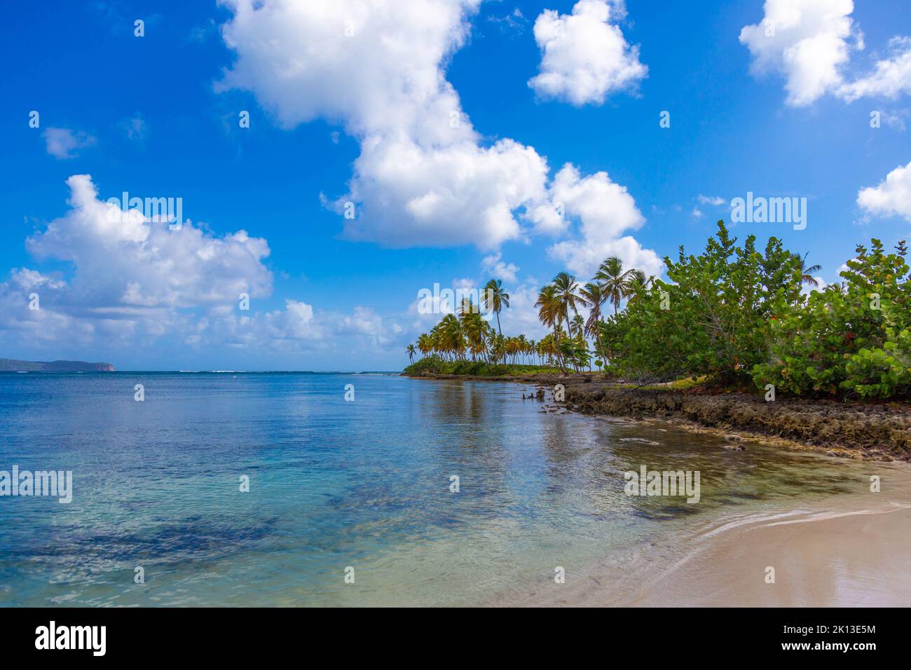 A beautiful view of a sandy beach and the sea on a bright cloudy day ...