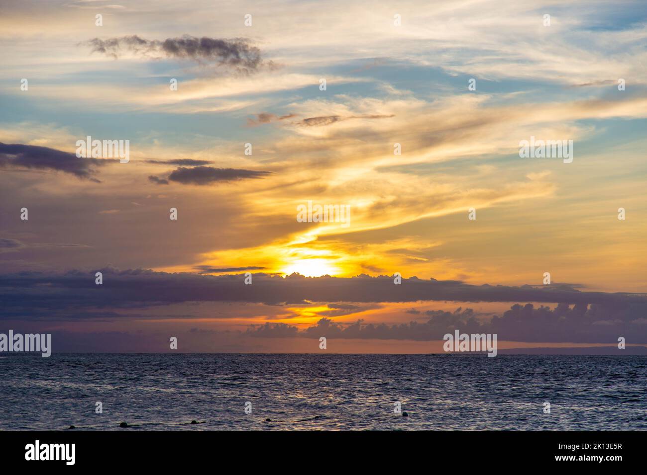 A beautiful view of a stunning golden sunset over the ocean Stock Photo ...