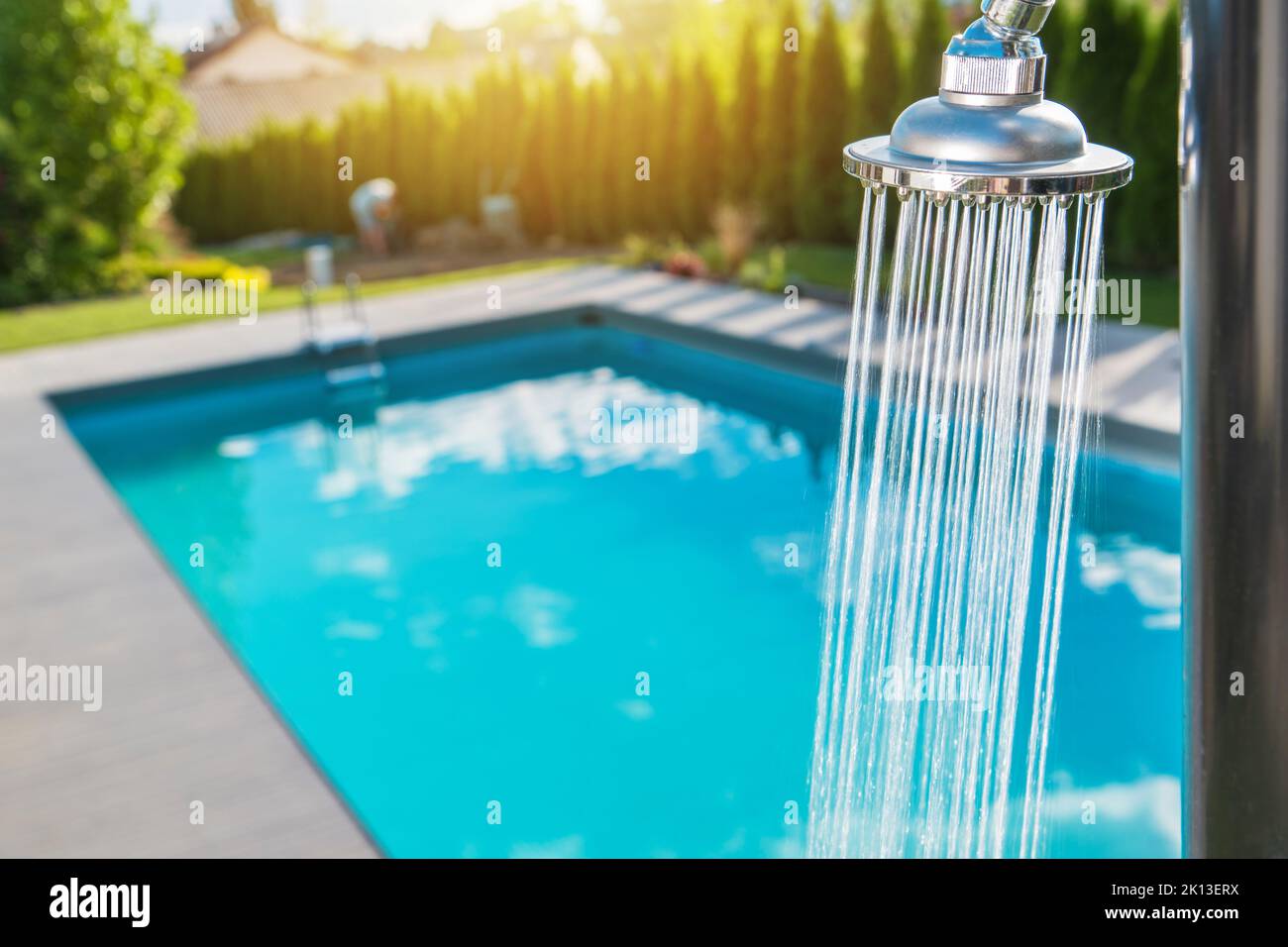 Running Outdoor Swimming Pool Shower. Residential Backyard Recreation. Stock Photo
