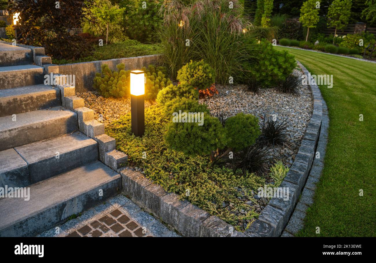 Residential Rockery Backyard Garden LED Outdoor Light Illumination. NIght Time Scenery. Stock Photo