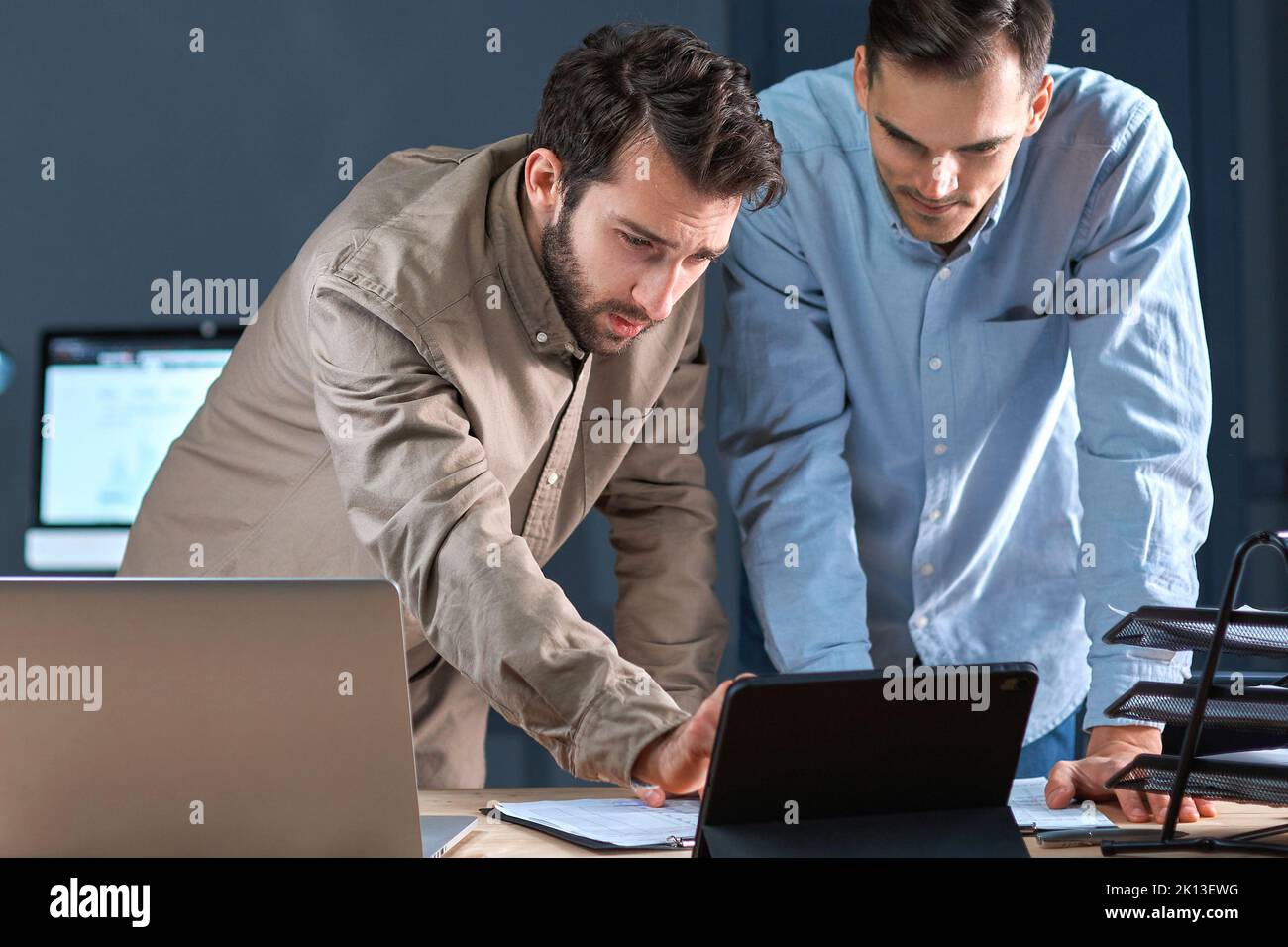 business colleagues using a digital tablet while working on a new project. Stock Photo