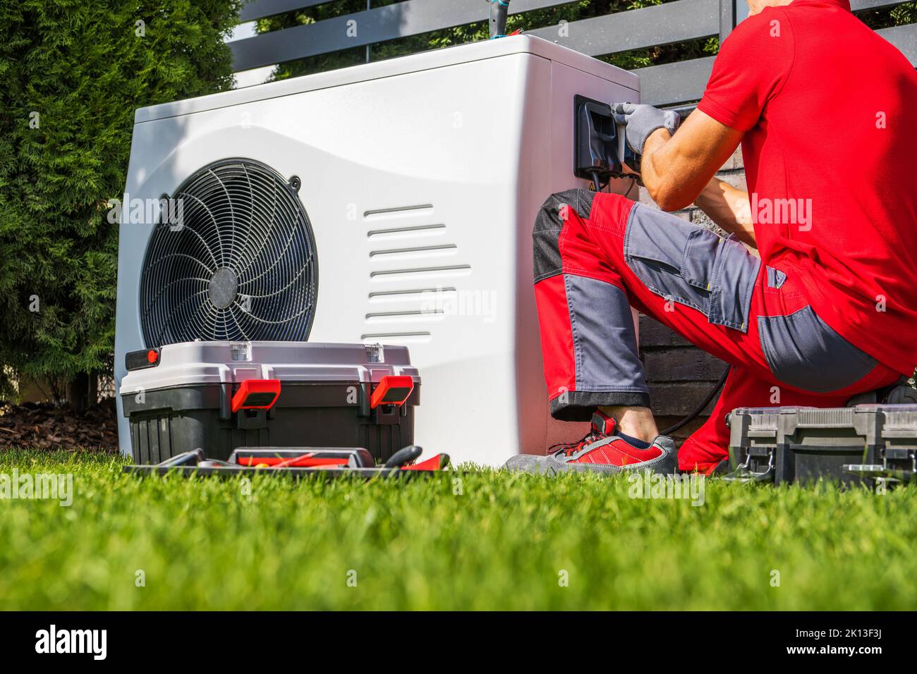 Backyard Swimming Pool Heat Pump Maintenance Performed by Caucasian