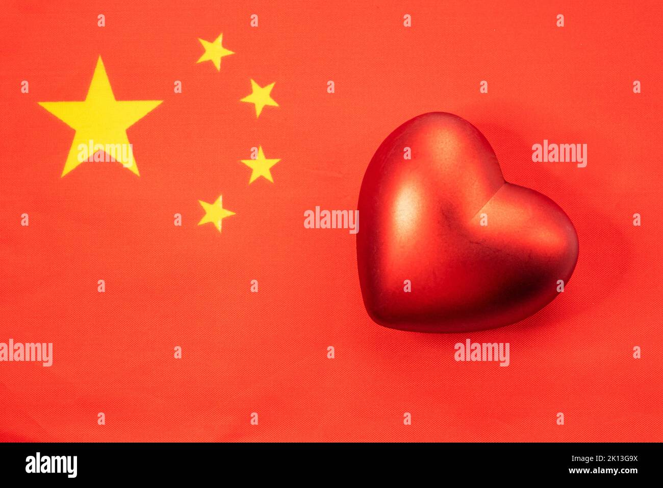 The red heart is on the flag of China. The concept of patriotic feelings for one's state. Patriotism Stock Photo