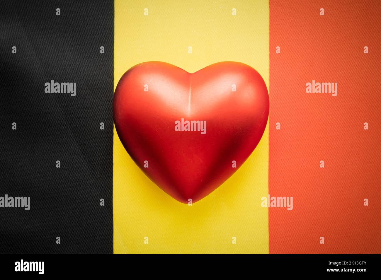 The red heart is on the flag of Belgium. The concept of patriotic feelings for one's state. Patriotism Stock Photo