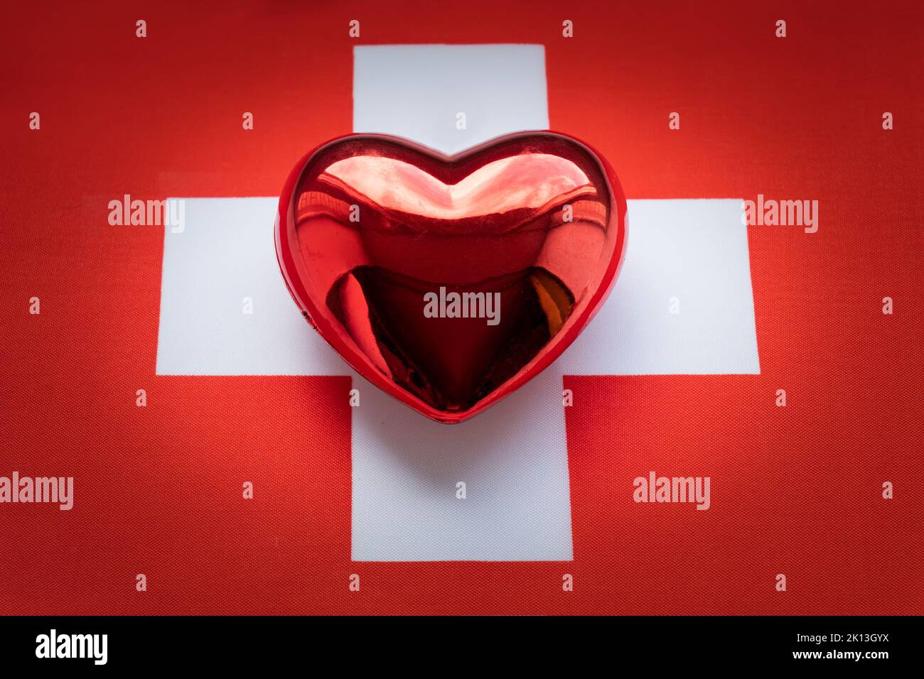 The red heart is on the flag of Switzerland. The concept of patriotic feelings for one's state. Patriotism Stock Photo