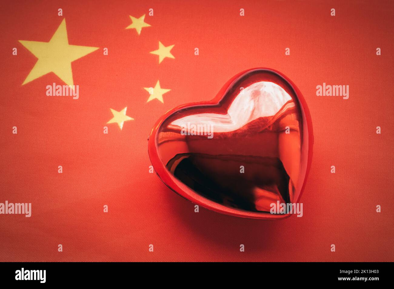 The red heart is on the flag of China. The concept of patriotic feelings for one's state. Patriotism Stock Photo