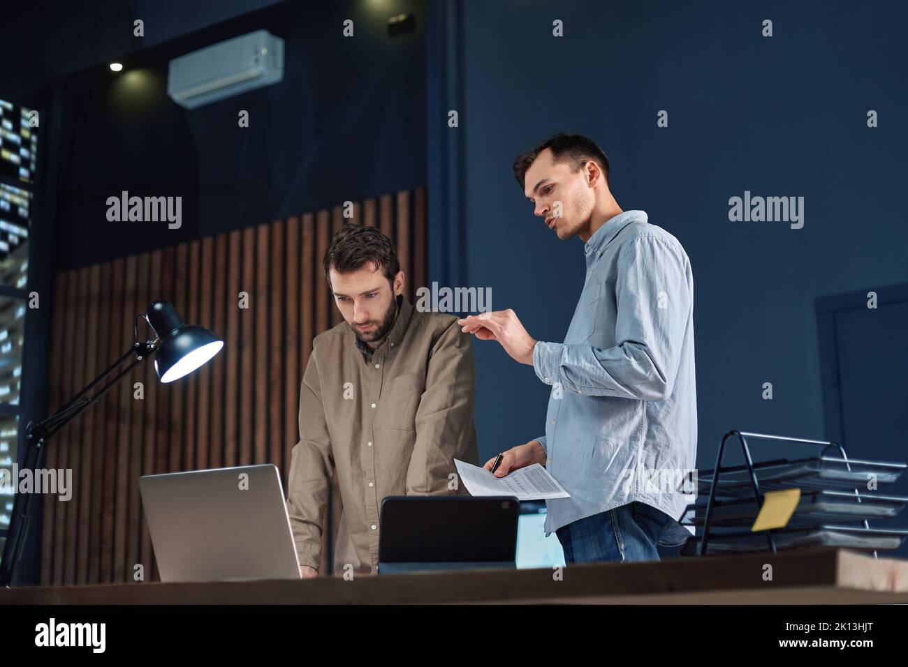 colleagues working working on a new project after hours. Stock Photo