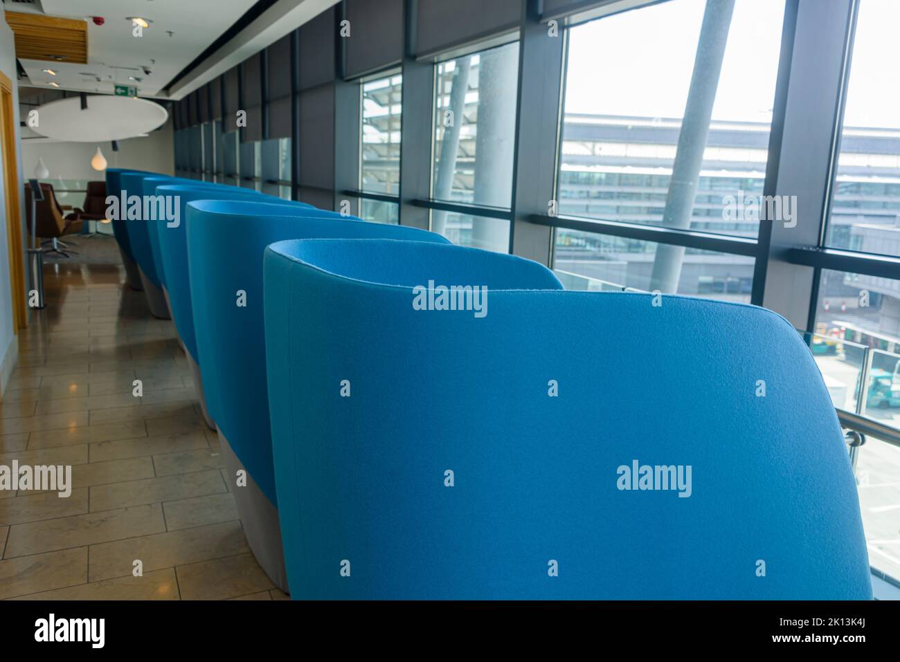 Individual pod chairs looking out the window at the business lounge in Dublin Airport, Ireland Stock Photo