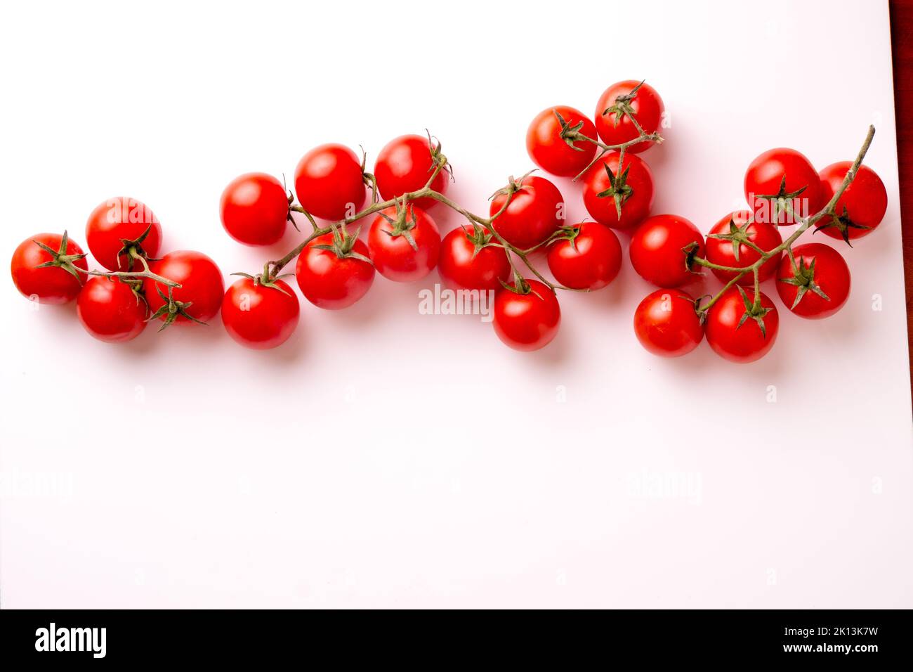 A top view of cherry tomatoes against white background Stock Photo - Alamy