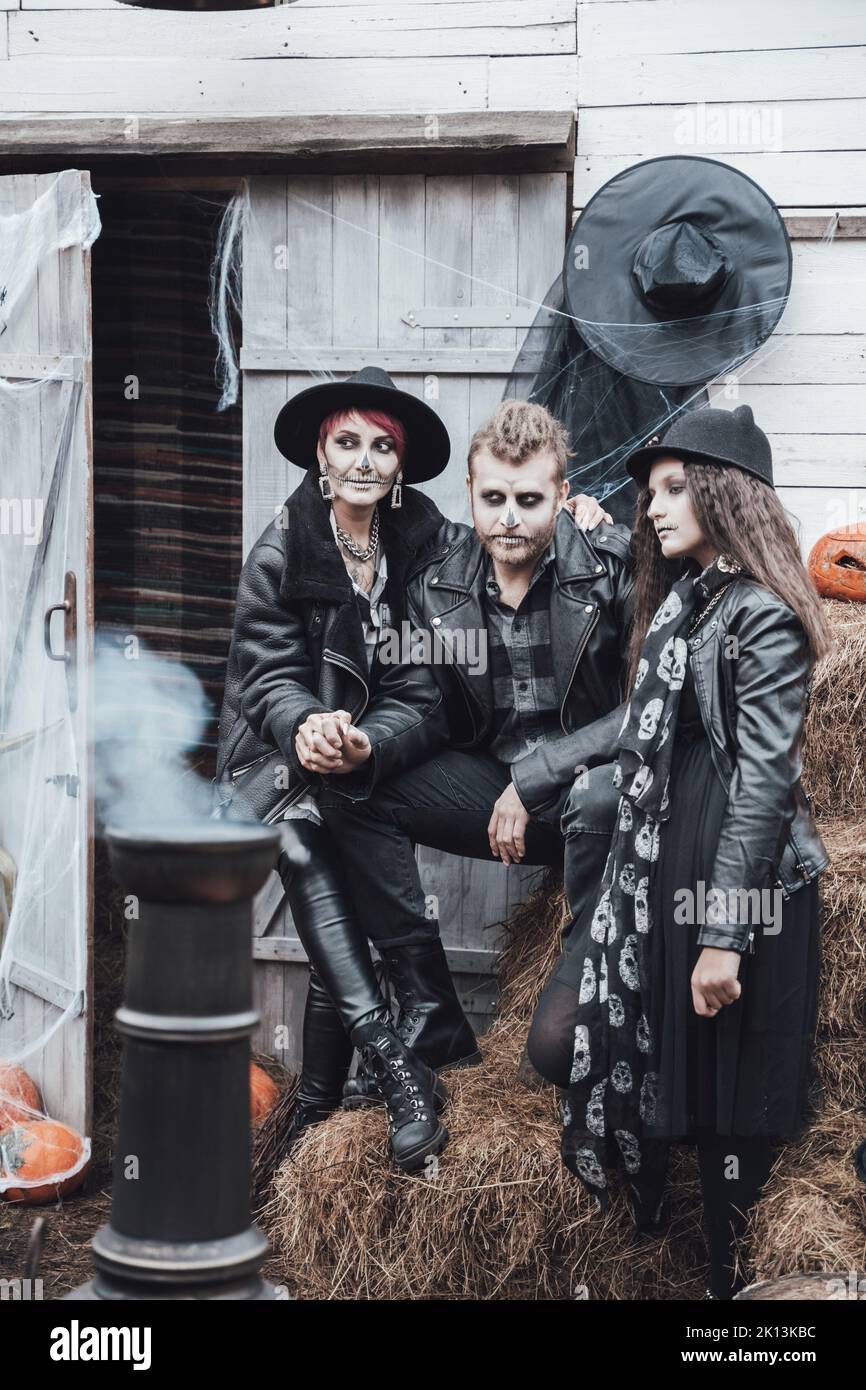 Scary family, mother, father, daughters celebrating halloween
