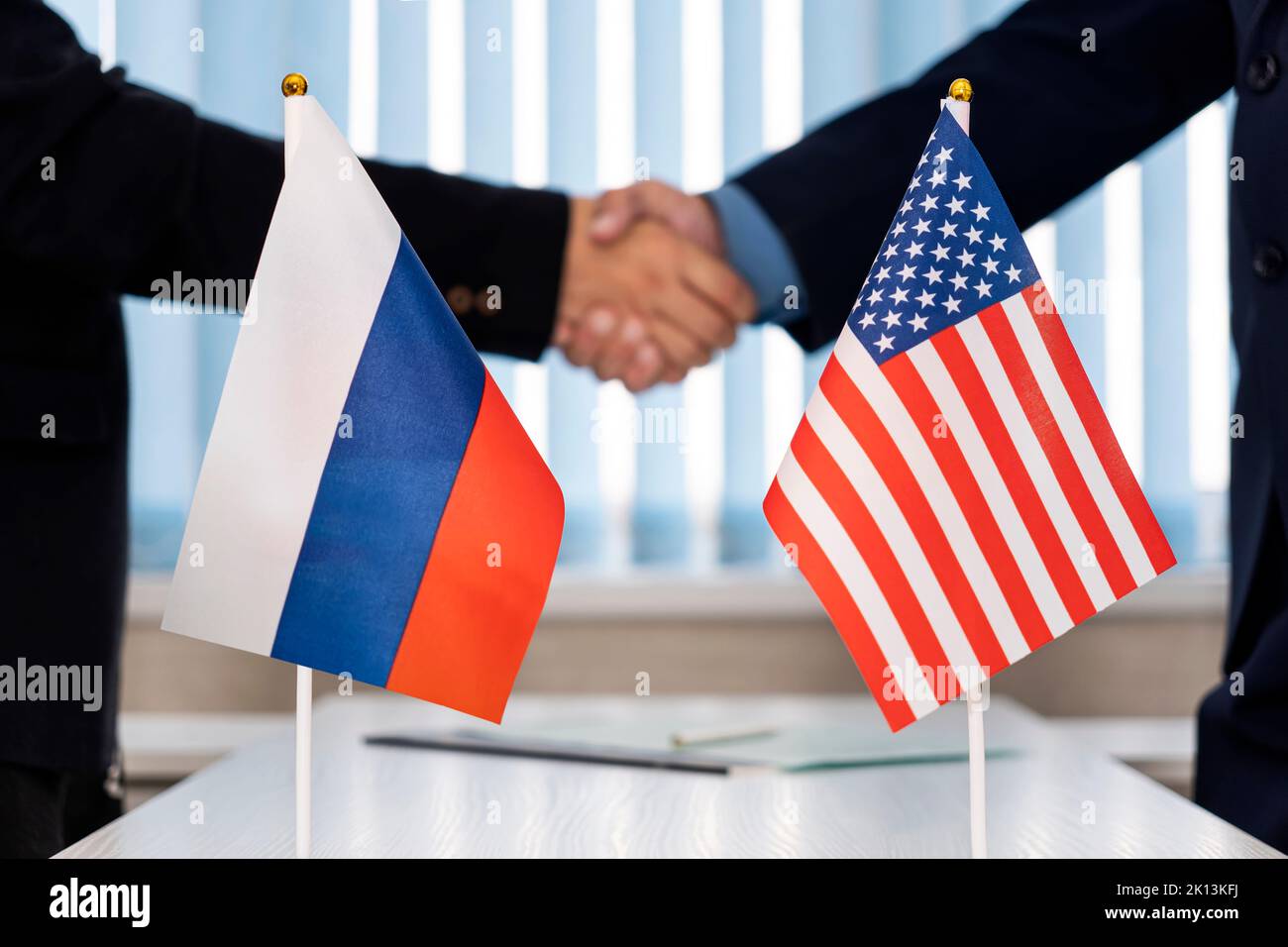 Political flags of russia and United States of America on table in international negotiation room. concept of negotiations, collaboration and cooperat Stock Photo