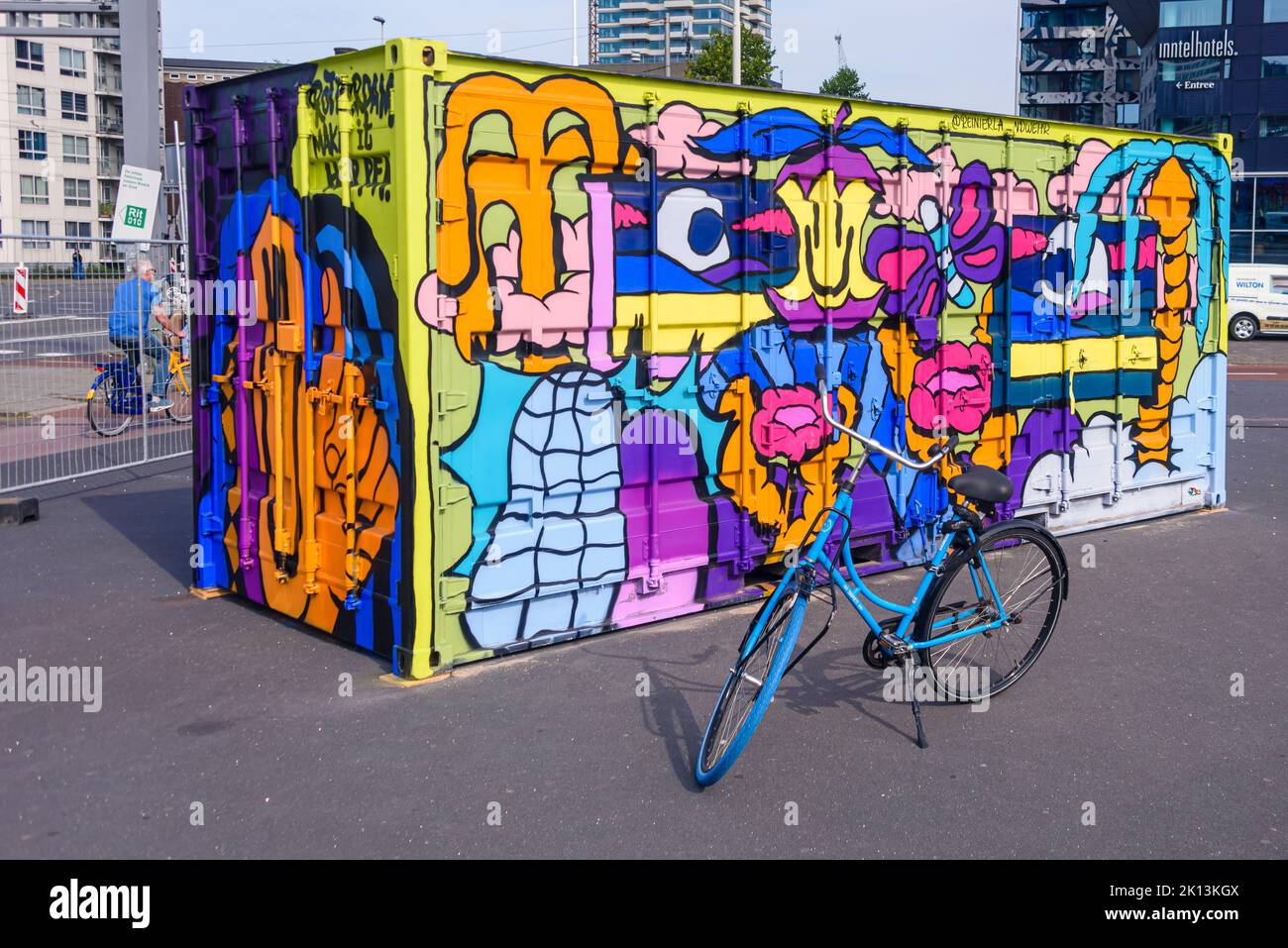 Colourful painted shipping container, with a bicycle parked in front at the Port of Rotterdam, Netherlands Stock Photo