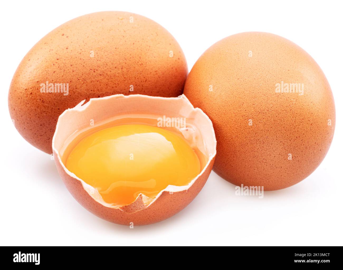 Brown chicken eggs and egg yolk isolated on white background. Stock Photo