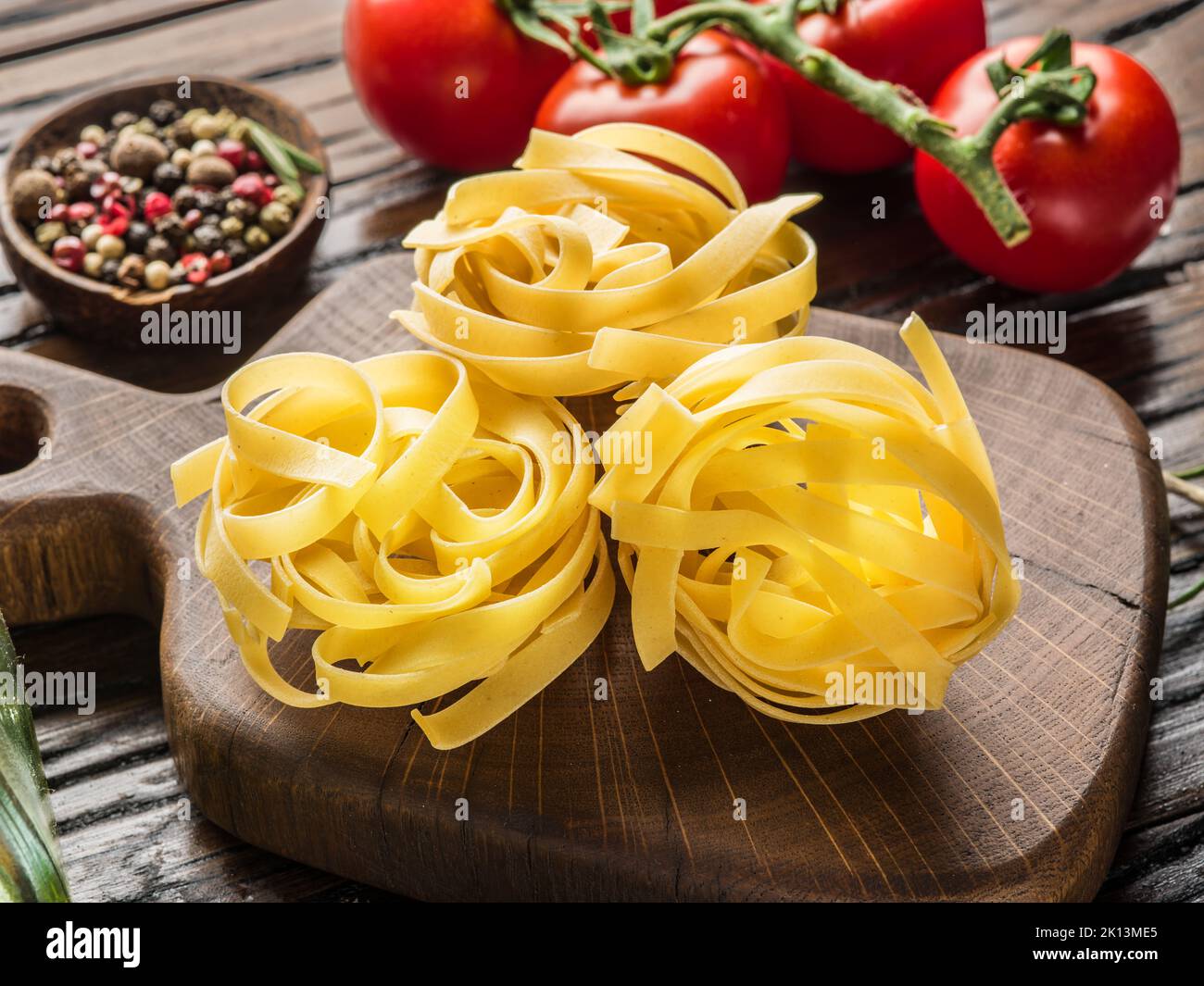 Tagliatelle pasta on wooden board close-up. Stock Photo