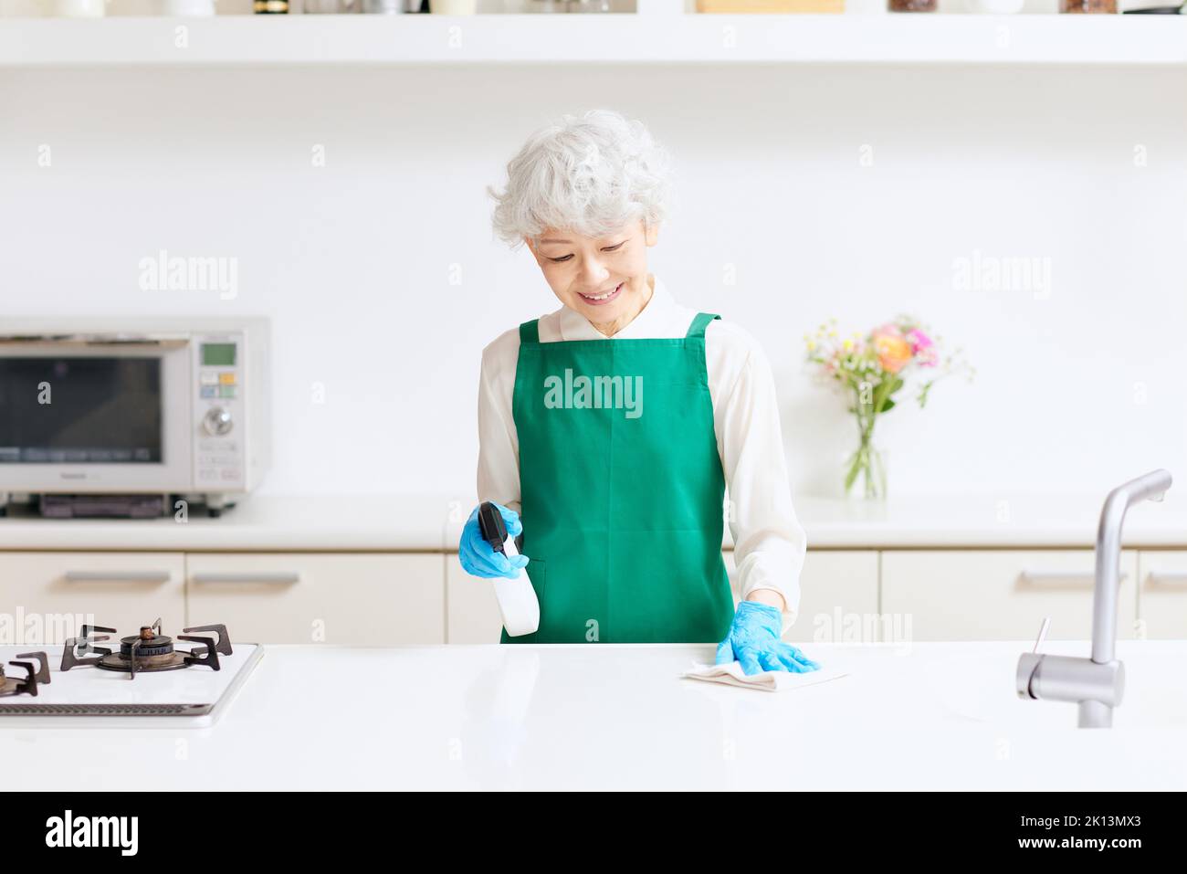 Senior woman cleaning kitchen hi-res stock photography and images - Alamy