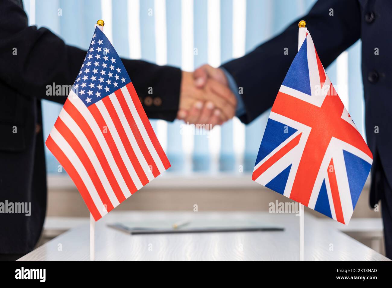 Political flags of United Kingdom and United States of America on table. concept of negotiations, collaboration and cooperation of countries. agreemen Stock Photo