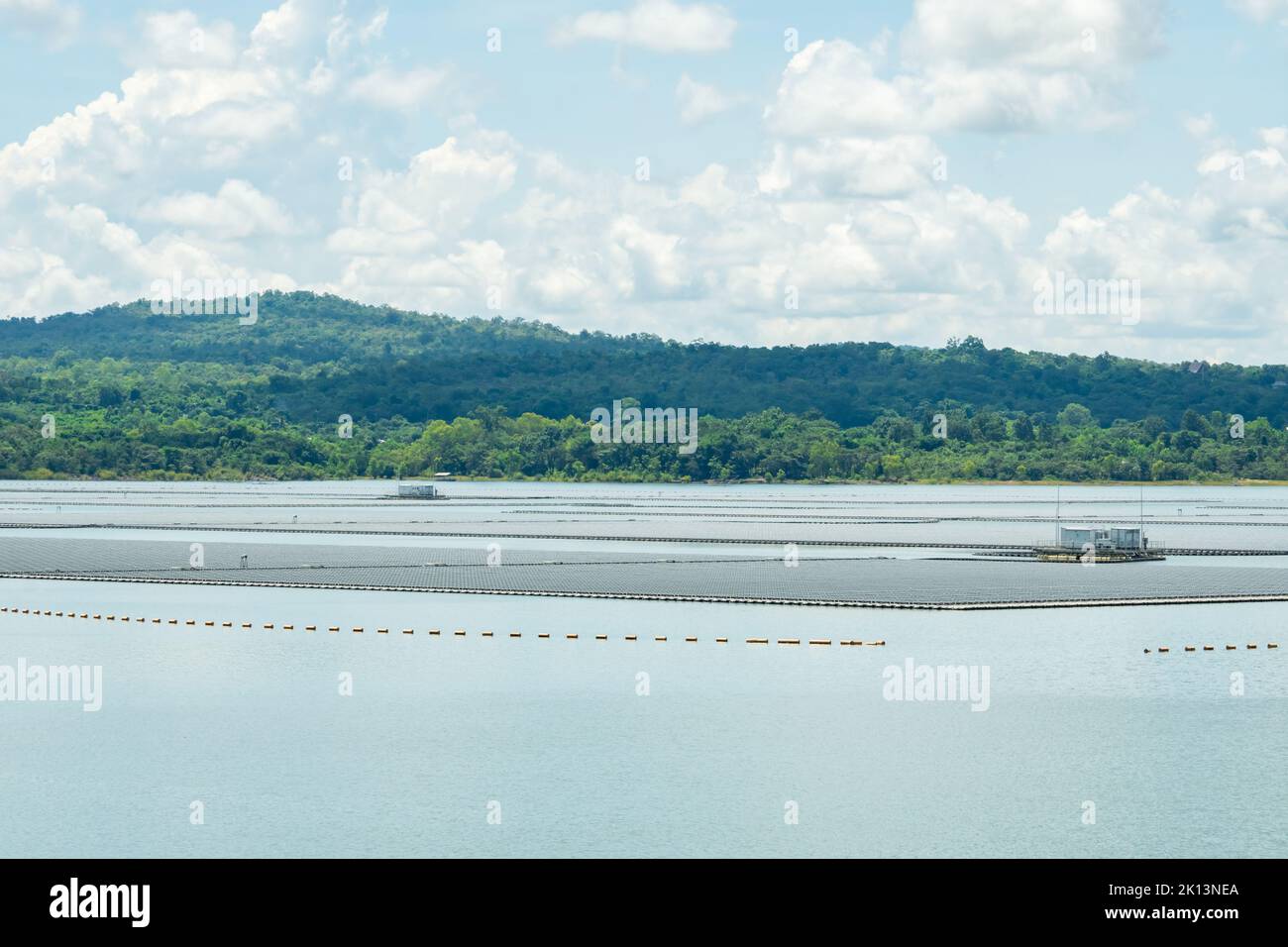 Floating solar farm or floating photovoltaics. Solar power. Landscape of solar panels floating on water in reservoir or lake. Solar technology. Stock Photo