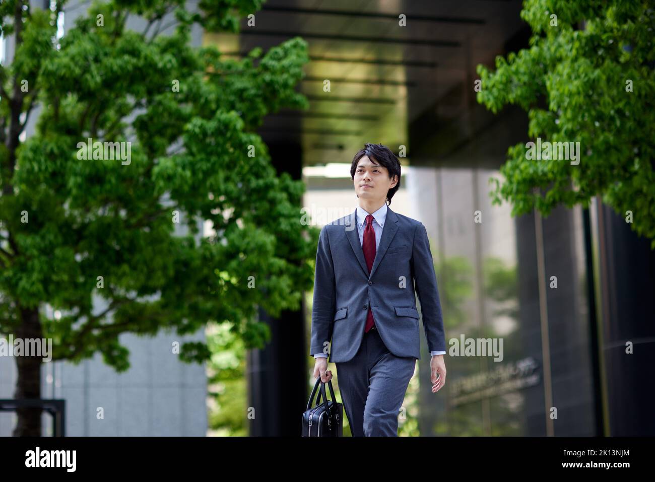 Japanese businessman walking in business district Stock Photo - Alamy