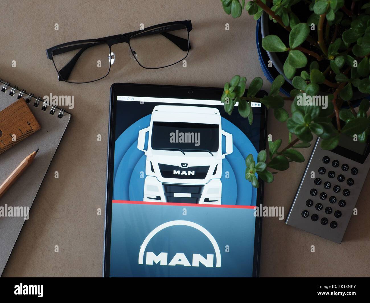 In this photo illustration, MAN Truck & Bus AG member of Traton Group logo seen displayed on a tablet Stock Photo