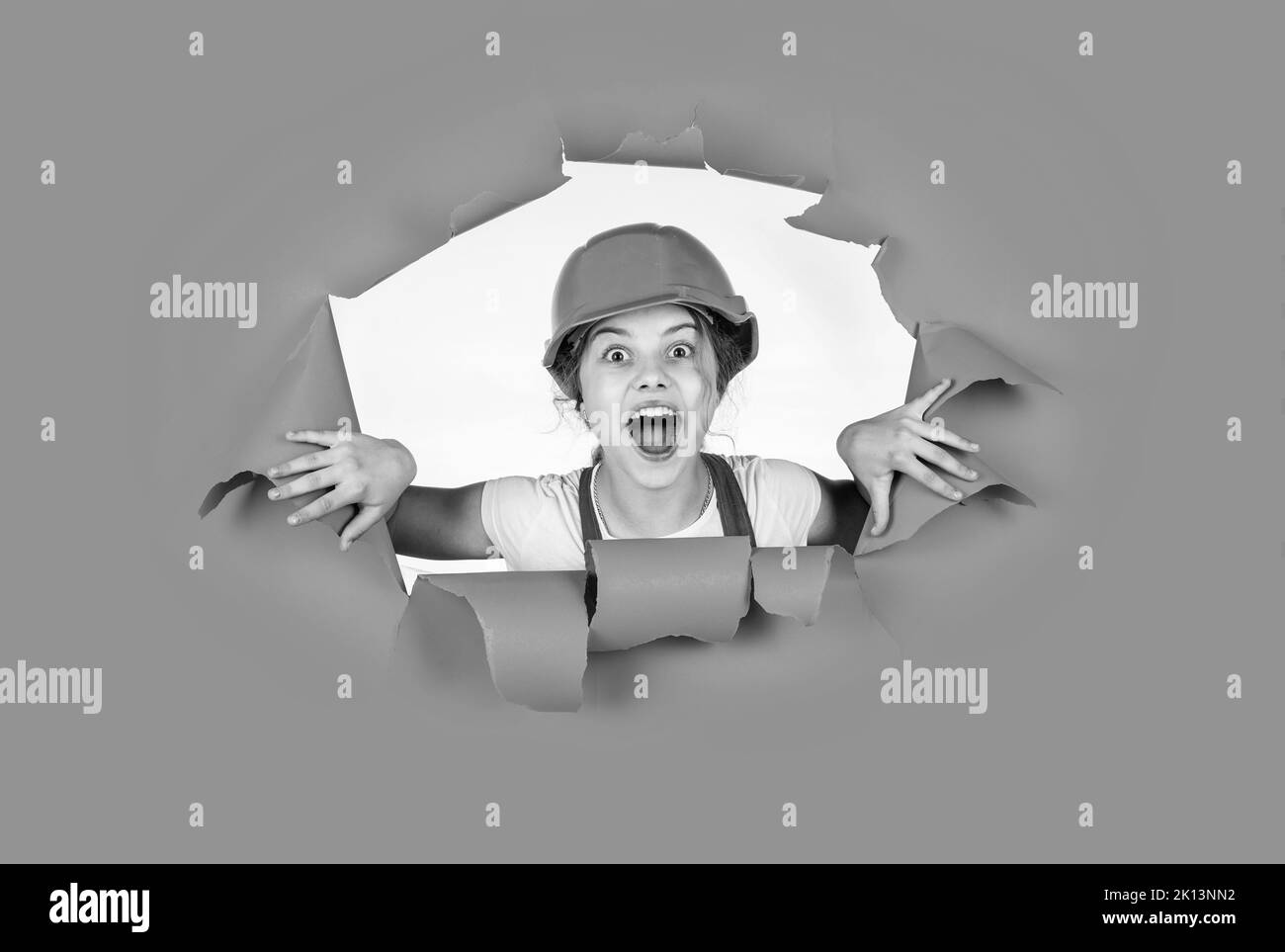 I think I can fix it. kid wear helmet on construction site. teen girl