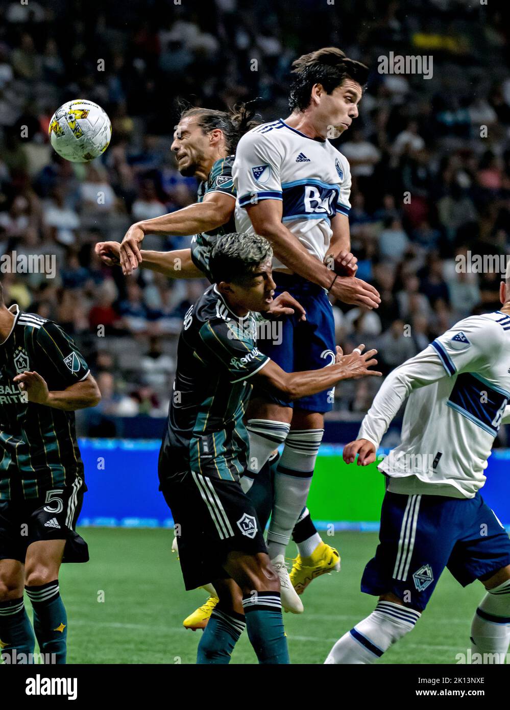 Vancouver, Canada. 14th Sep, 2022. Martin Caceres of LA Galaxy (top, L) and Brian White of Vancouver Whitecaps FC compete for the ball during the 2022 Major League Soccer (MLS) match between Vancouver Whitecaps FC and LA Galaxy at BC Place stadium in Vancouver, Canada, Sept. 14, 2022. Credit: Andrew Soong/Xinhua/Alamy Live News Stock Photo