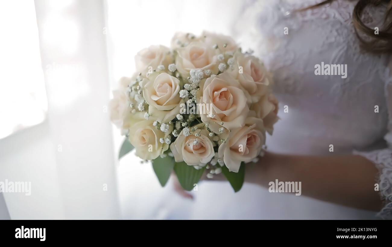 Bride in wedding dress holding beautiful white wedding flowers bouquet ...