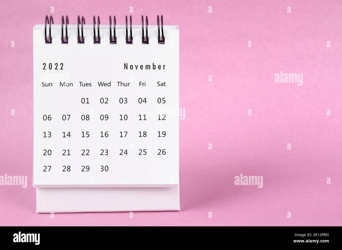 November 2022 Monthly desk calendar for 2022 year on pink background. Stock Photo