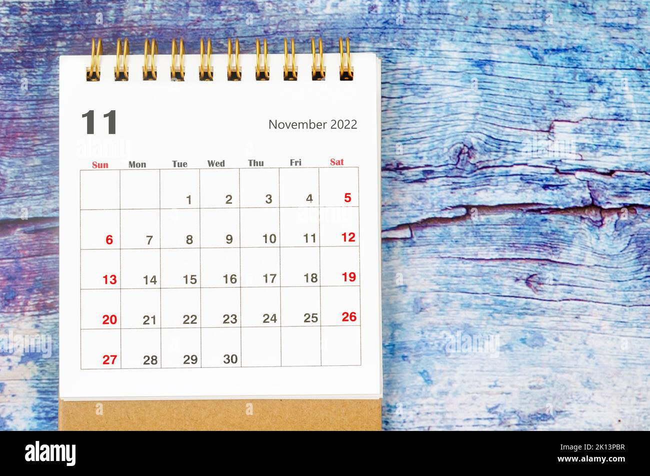 November 2022 Monthly desk calendar for 2022 year on old blue wooden background. Stock Photo